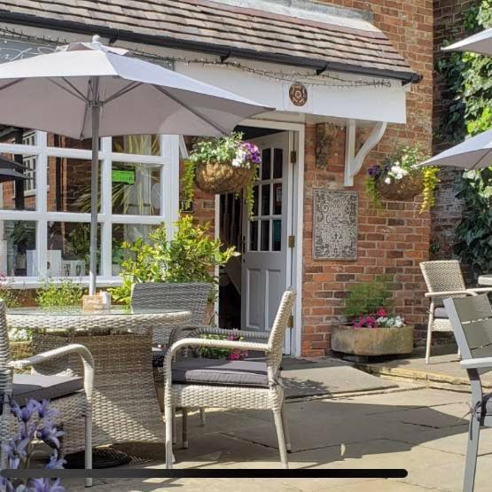 The Courtyard Cafe exterior with parasols and hanging baskets