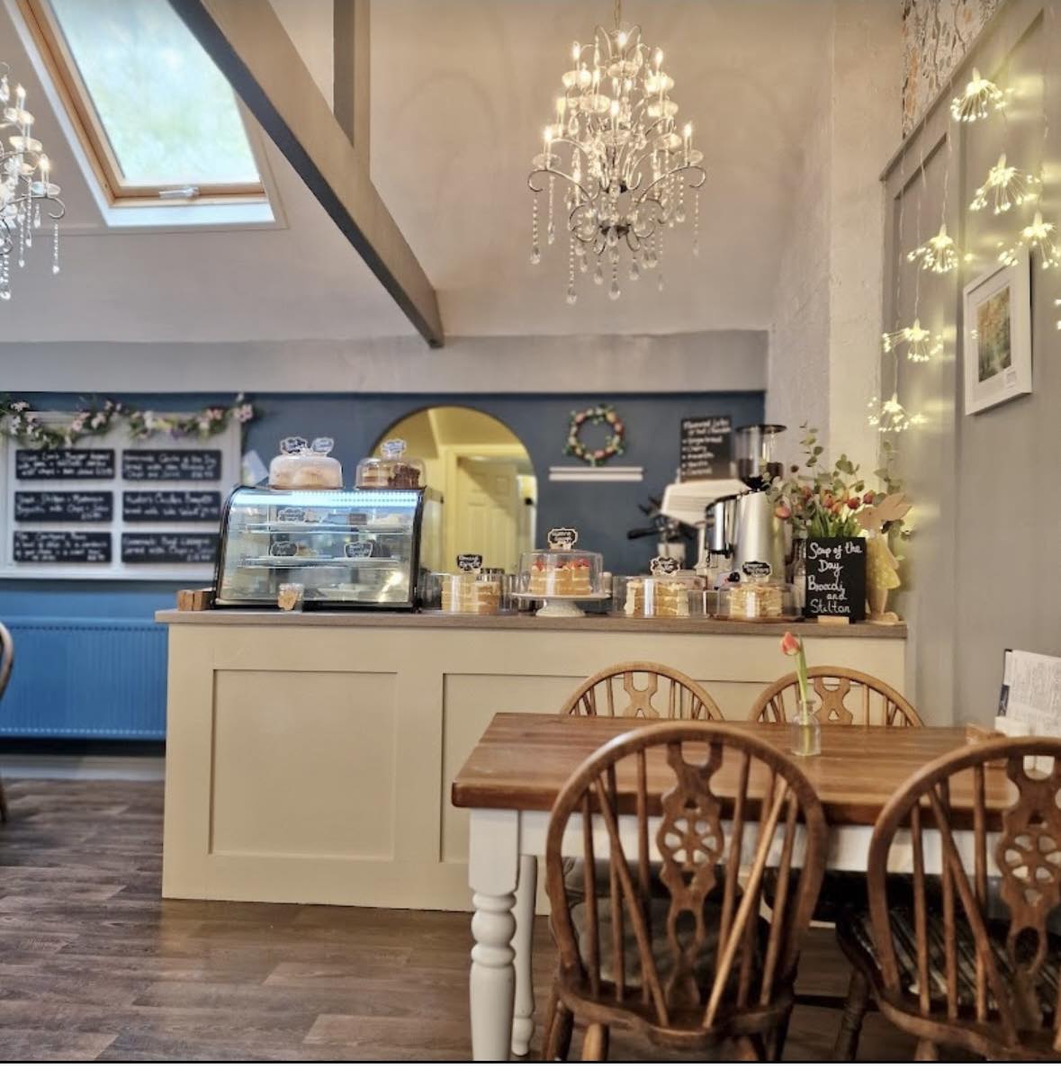 Inside The Courtyard Cafe - chandeliers, duck egg blue walls, farmhouse tables